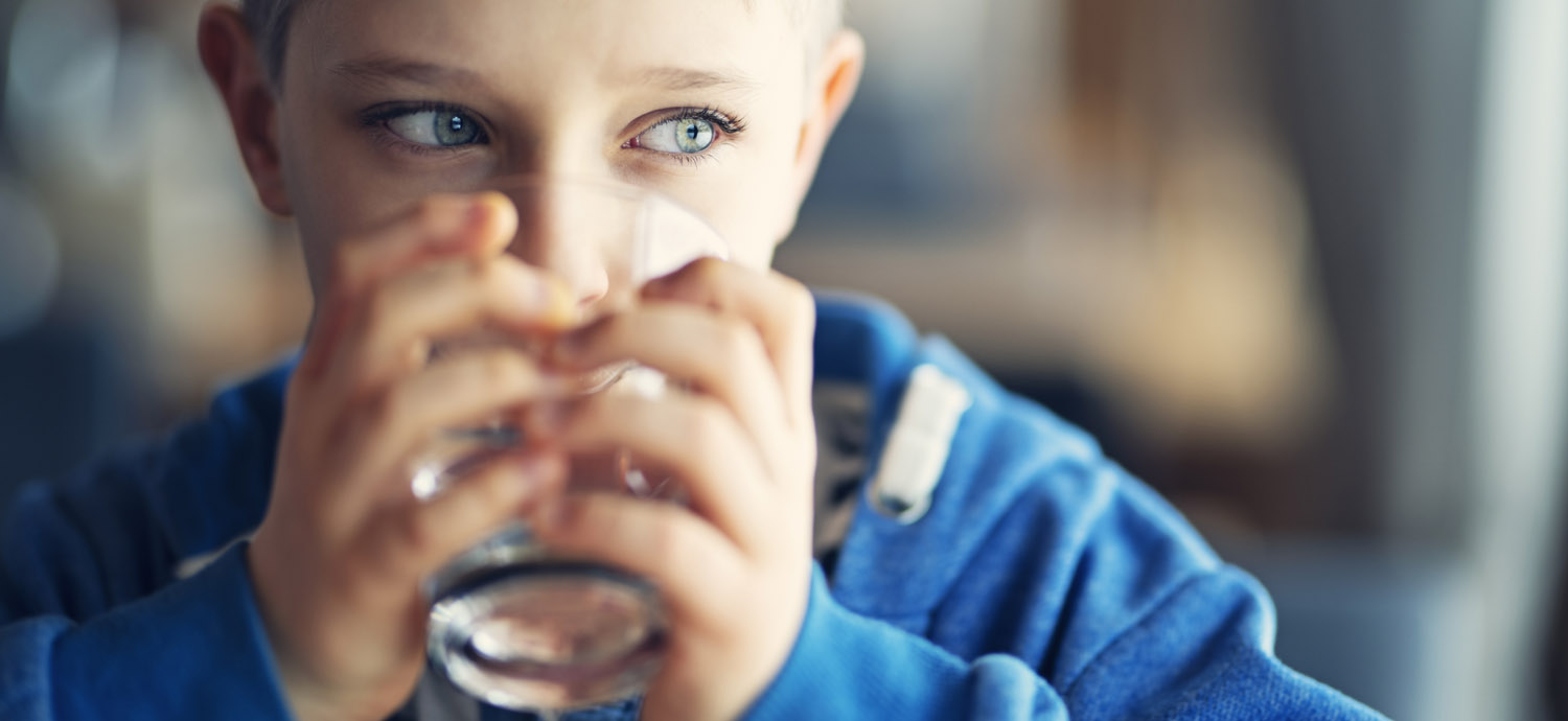 Boy drinking water from glass