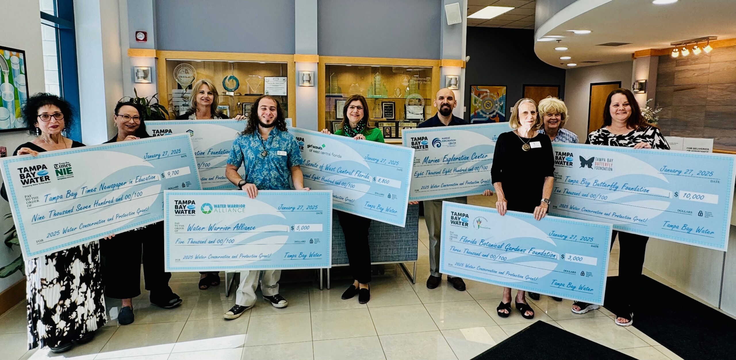 The seven 2024 Water Conservation and Protection Mini-grant Recipients with their ceremonial checks.